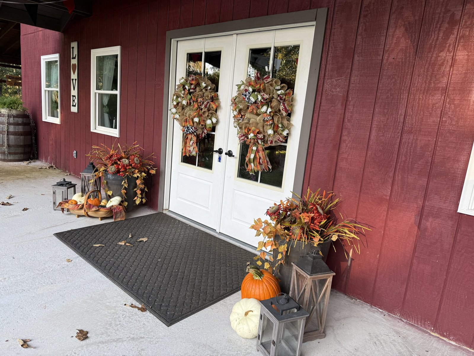 Grandpas Barn front doors decorated with fall wreaths